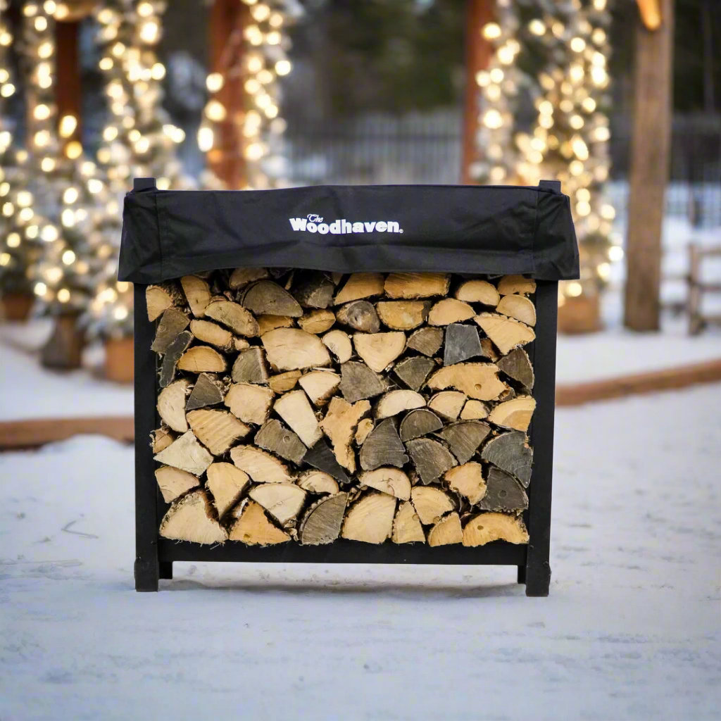 Woodhaven 3 ft Firewood Rack with seasoning cover in black finish holding stacked firewood