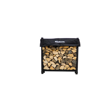 Woodhaven 3 ft Firewood Rack with seasoning cover in black finish holding stacked firewood