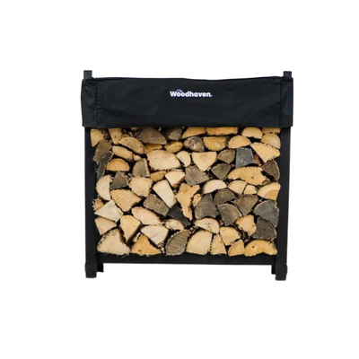 Woodhaven 3 ft Firewood Rack with seasoning cover in black finish holding stacked firewood