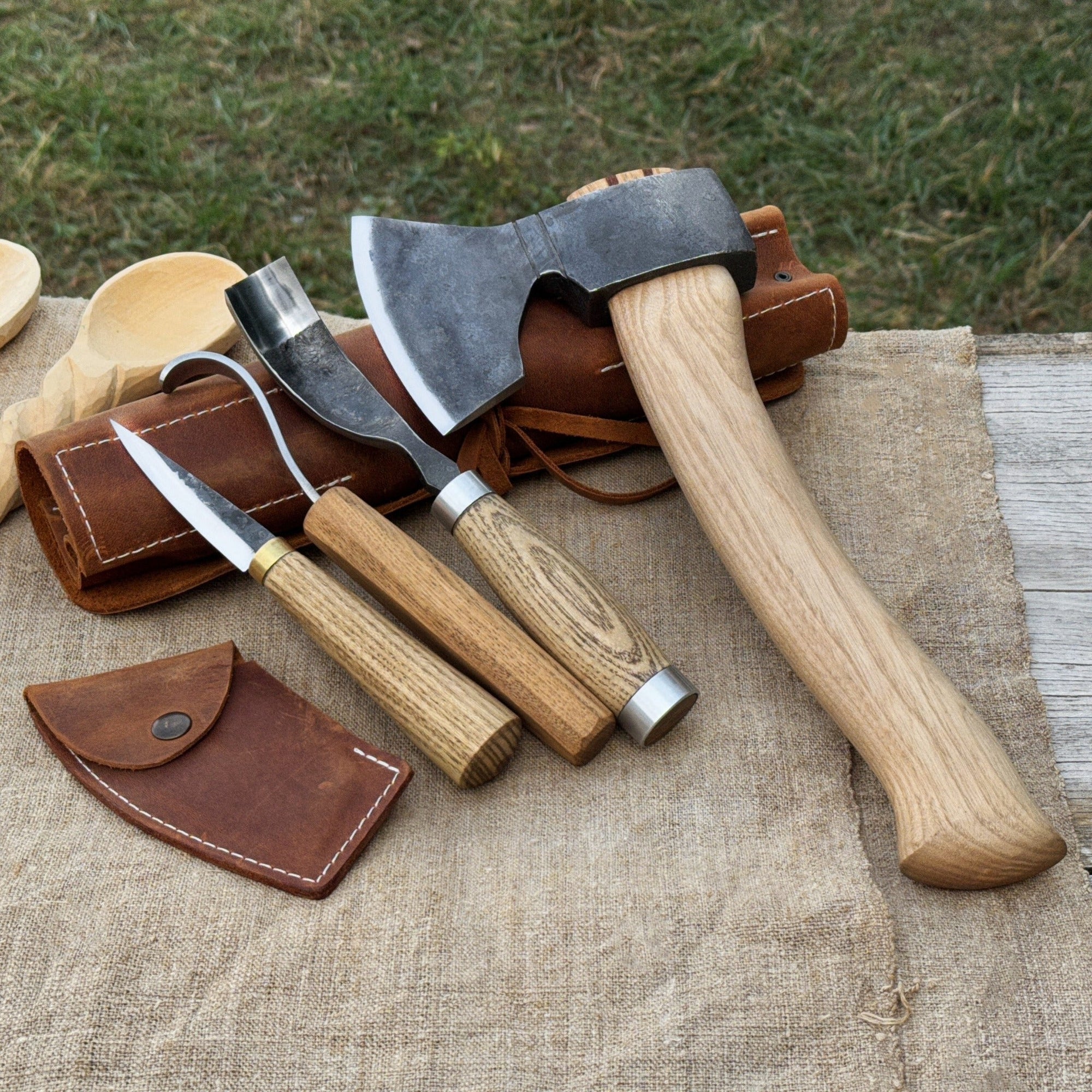 4-Piece Spoon Carving Tool Set with carving axe, sloyd knife, hook knife, bent gouge, and leather roll