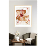 Abstract floral painting with broad brushstrokes in warm browns and reds on a creamy white background, framed in light wood hanging above a cozy seating area.