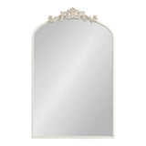 Rectangular wall mirror with a rounded arch top, featuring an ornate cream-colored carved floral decoration centered on the top edge.