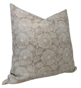 Square pillow cover in beige with an embroidered floral pattern featuring circular flowers and detailed leaves in white thread.
