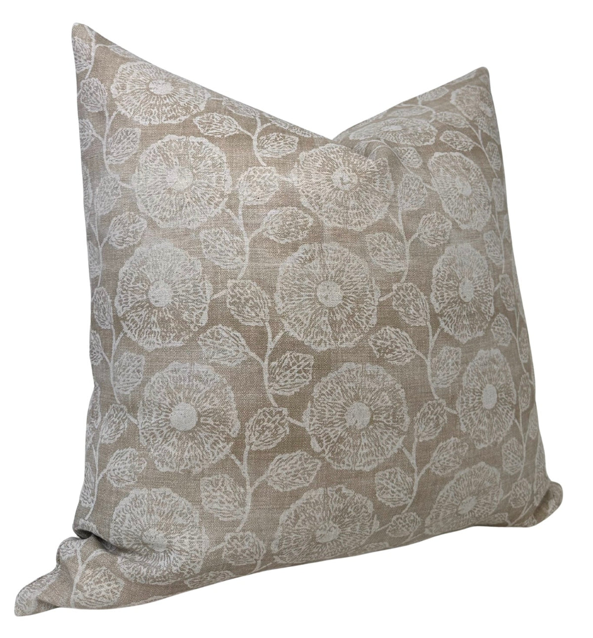 Square pillow cover in beige with an embroidered floral pattern featuring circular flowers and detailed leaves in white thread.
