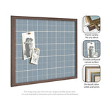 Wall-mounted fabric pinboard with light blue plaid pattern and brown wood frame, displaying two black-and-white photos pinned on its surface.