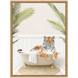 Tiger lounging in a vintage clawfoot tub with a white towel draped over the side, surrounded by green palm leaves in a bright, white-paneled room.