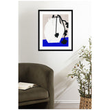 Abstract art print with a white vase and black floral shapes over a split background of light beige and vibrant blue, framed in black and displayed on a white wall.