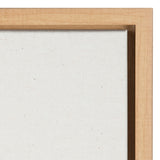 Close-up of a plain white canvas in a light natural wood frame showing fabric texture and wood grain corner detail.