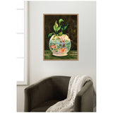 Painting of a round glass bowl with water, aquatic plants, and orange goldfish on a dark green surface, framed and hanging above a gray armchair with a knit throw.