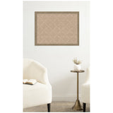 Rectangular beige pinboard with a subtle white lattice pattern framed in wood, hanging on a white wall above a brass side table between two white upholstered chairs.