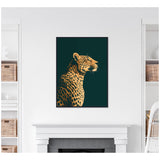 Profile of a gilded cheetah with detailed spots on a dark emerald green background, framed and hung above a white fireplace mantel.