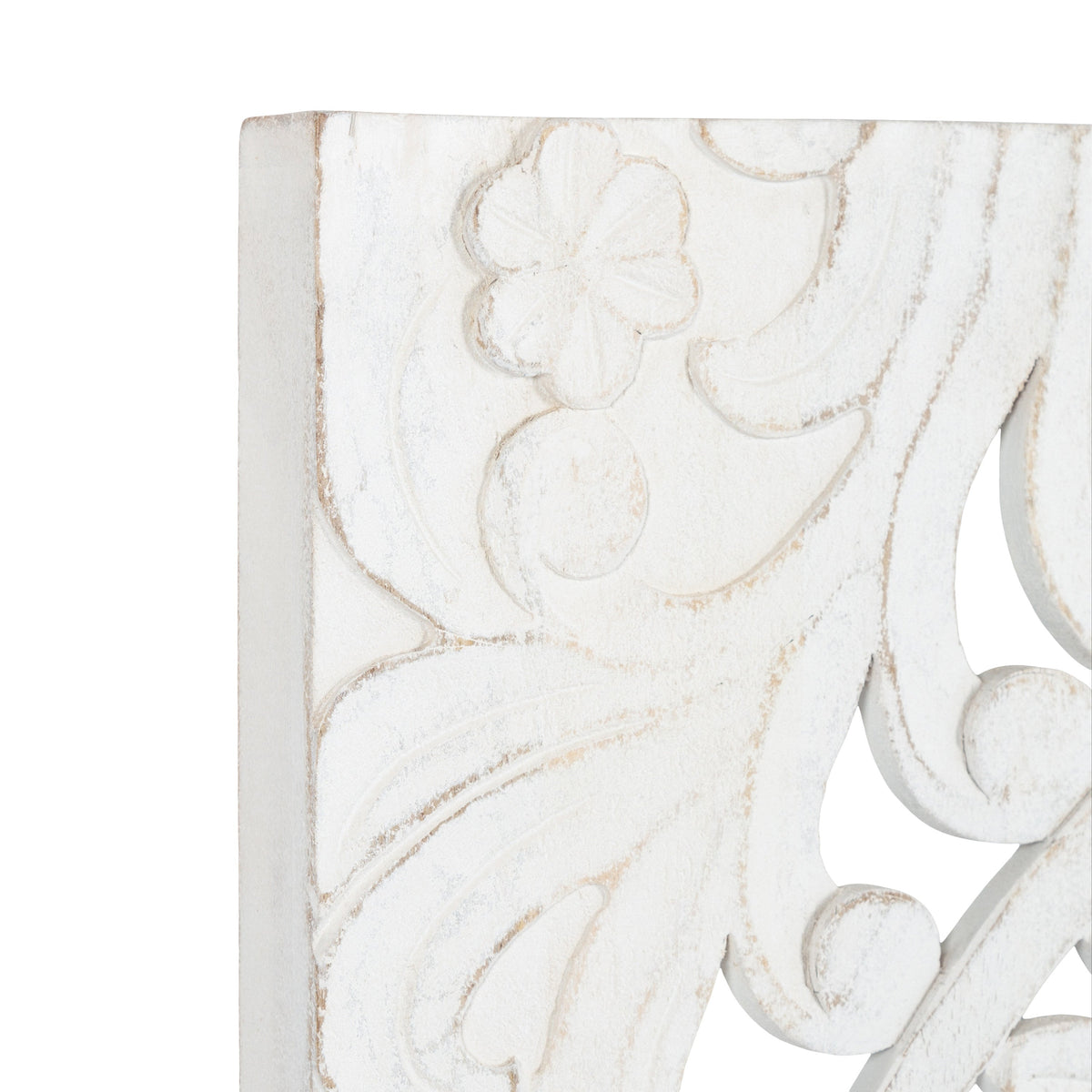 Close-up of white distressed carved wood panel featuring floral and scroll motifs with subtle beige highlights