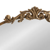 Curved traditional arch mirror topped with an ornate golden frame featuring symmetrical scrollwork and a central leaf motif.
