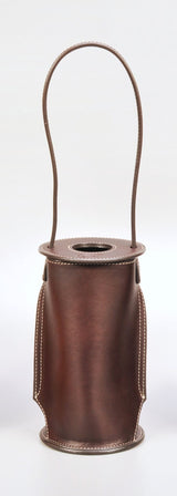 Brown leather wine tote with rounded body, visible stitching, and a large loop handle extending upward from the circular top opening.
