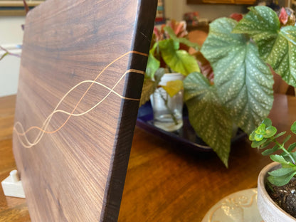 Handcrafted walnut charcuterie board with cherry and maple decorative banding