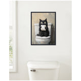 Framed painting of a fluffy black cat holding a toilet paper roll while sitting on a white toilet against a neutral background, hanging above a toilet tank in a bathroom.