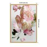 Soft pink and cream roses in a close-up bouquet with green leaves against a light background, framed in a simple light wood frame with 23x33 inch dimensions.