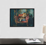 Painting of a lion lounging on a tufted red armchair, with dark teal and gold brushstrokes in the background, framed in black and hung on a white wall above a desk.