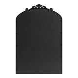 Back view of a rectangular mirror with an arched top and decorative black metal frame featuring ornate scrollwork at the apex.