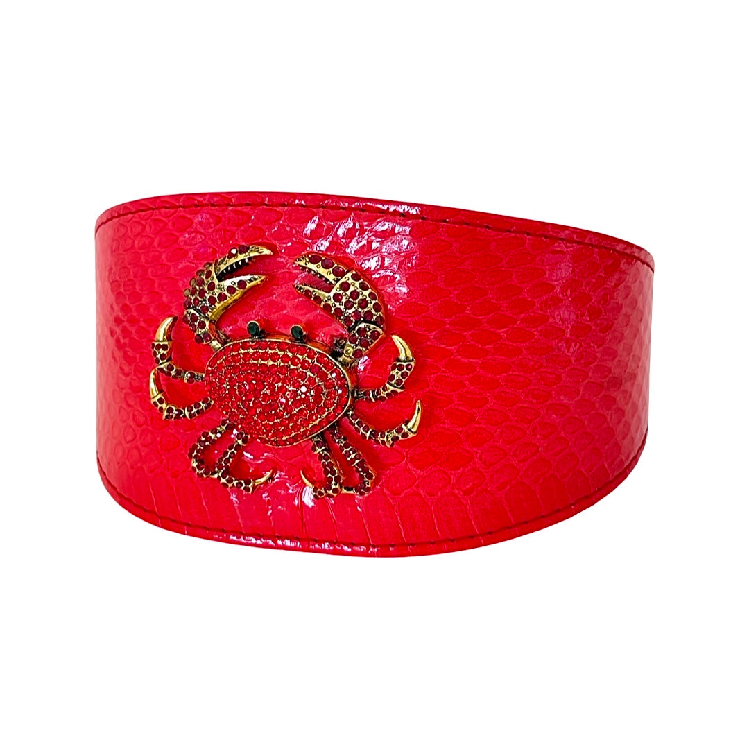 Wide red collar with a glossy snake texture featuring a gold-tone rhinestone crab shaped accessory in the center front.