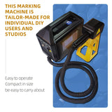 Compact black portable laser marking machine with a flexible hose connected to a yellow laser head, presented on a blue patterned surface.