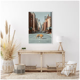 Framed canvas with a tiger walking across an empty city street, surrounded by tall buildings, hanging above a wooden console table in a minimalist room.