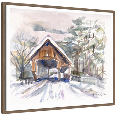 Framed canvas art showing a snowy covered bridge in Vermont surrounded by trees, painted in delicate watercolor by Patricia Shaw.
