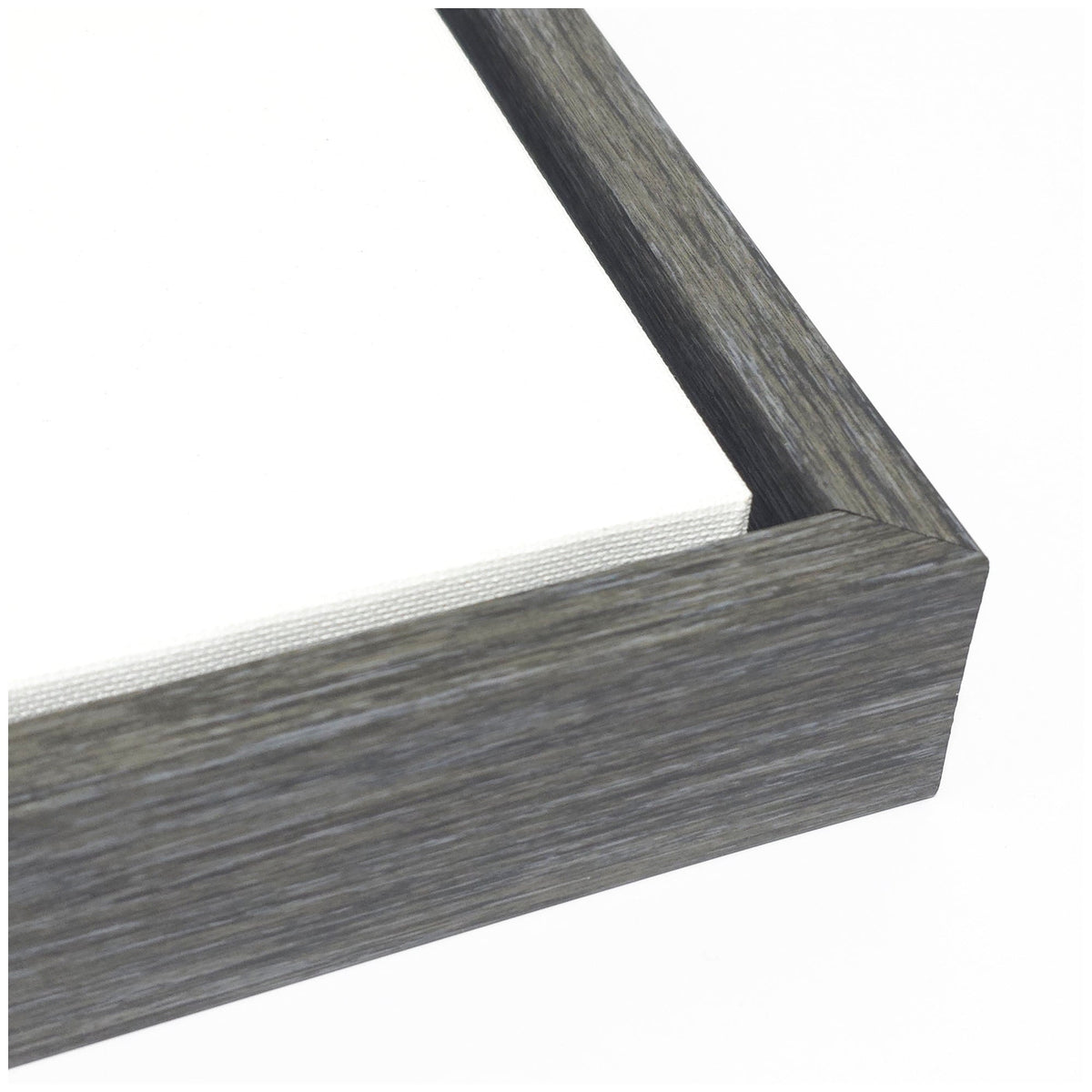 Close-up of a textured gray wood frame corner enclosing a white canvas, highlighting the wood grain and clean lines of the framing.