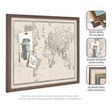 Large vintage-style black and white world map printed on a linen fabric pinboard, framed in dark wood with photos pinned to the surface.