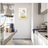 Modern kitchen with white cabinets and gray countertops featuring a framed canvas of penguins in a vintage yellow bathtub on a floral background hung on the wall.