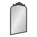 Tall rectangular mirror with an arched top and ornate black metal frame featuring intricate Baroque-style scrollwork at the arch apex.
