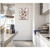 Minimalist kitchen with concrete countertops and white cabinets, featuring a framed muted floral artwork with beige and blush tones on the wall.