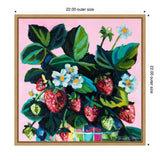 Colorful painting of ripe and unripe strawberries with green leaves and white flowers on a bright pink background, framed with a light wooden border.