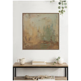 Abstract canvas wall art with blended sage green, beige, and brown brushstrokes in a simple dark frame, displayed above a wooden shelf with books, mug, and small vase.