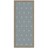 Rectangular blue fabric pinboard with an evenly spaced pattern of small, white botanical block prints, framed in light brown wood.