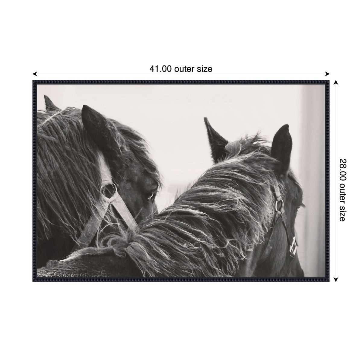 Black and white close-up of two black horses with bridles, one facing forward and the other turned slightly, highlighting their manes and ears.