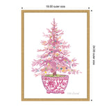 Watercolor painting of a pink Christmas tree decorated with multicolored ornaments, set in a red and white patterned ceramic pot, framed in light wood.