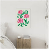 Minimalist room with white wall featuring framed canvas of stylized pink flowers with green stems, wooden bedside table holding books and a white cup, adjacent to bed and white louvered door.
