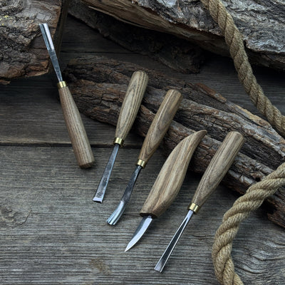 5-piece wood carving tool set with whittling knife and four chisels on wooden surface