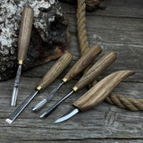 5-piece wood carving tool set with whittling knife and four chisels on wooden surface