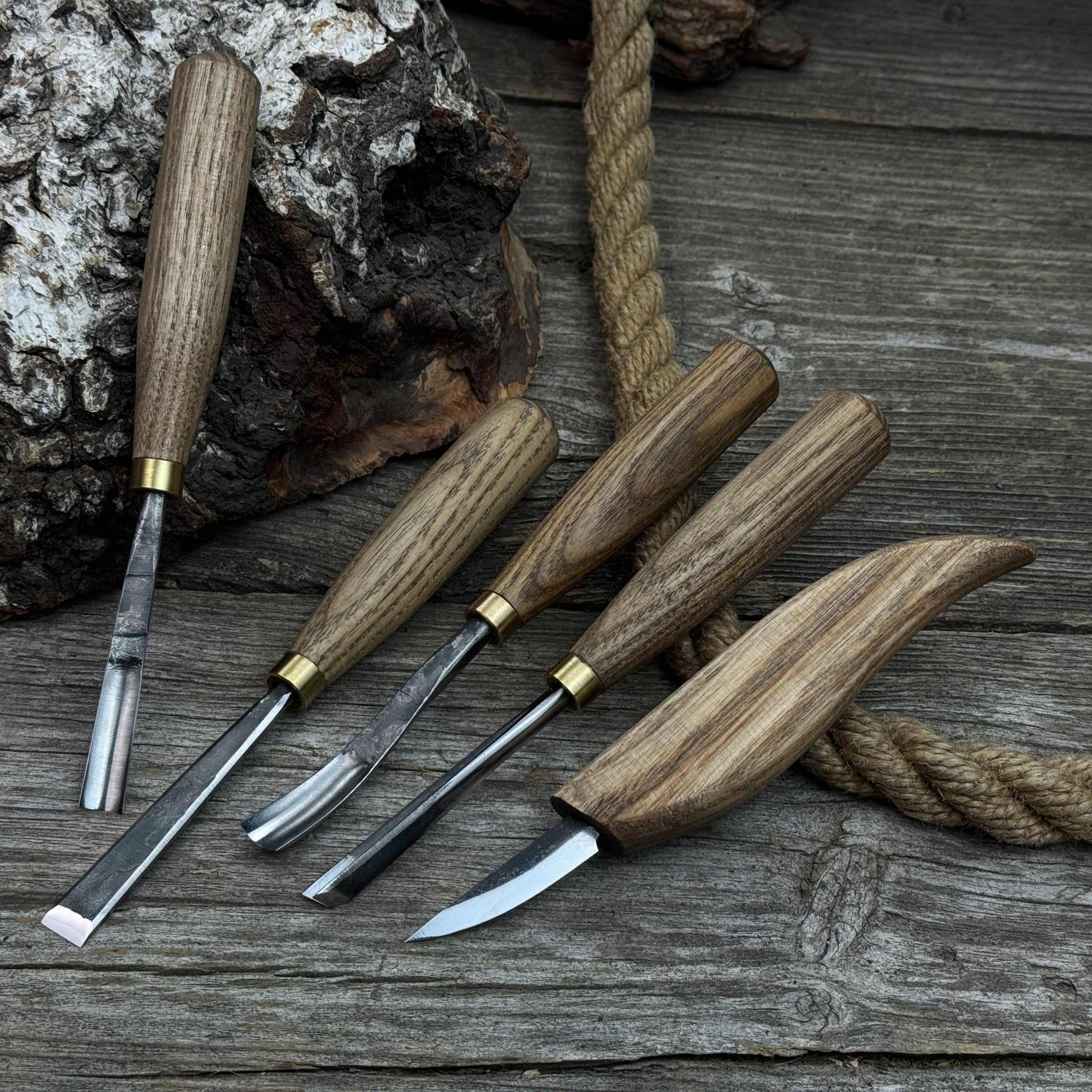 5-piece wood carving tool set with whittling knife and four chisels on wooden surface