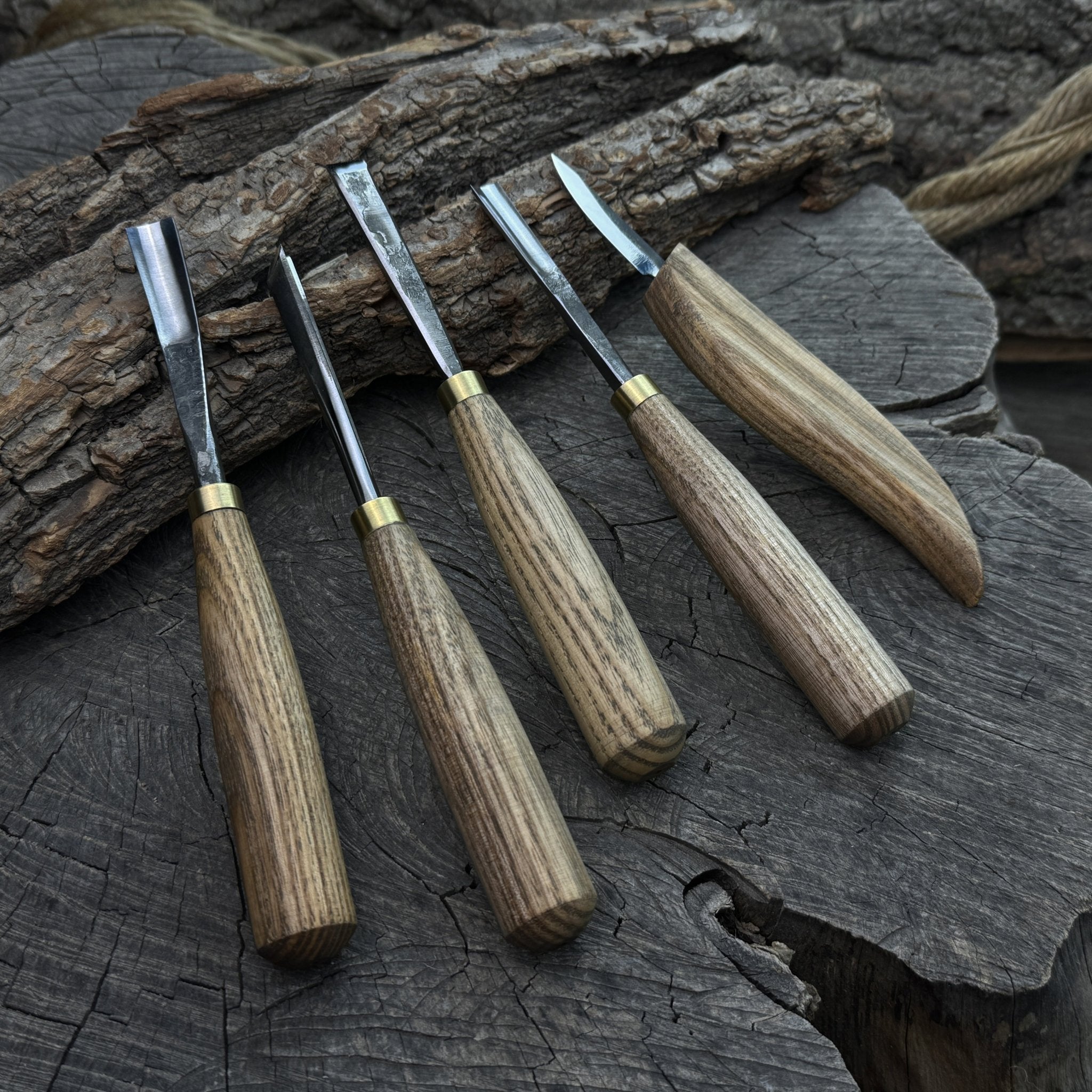 5-piece wood carving tool set with whittling knife and four chisels on wooden surface