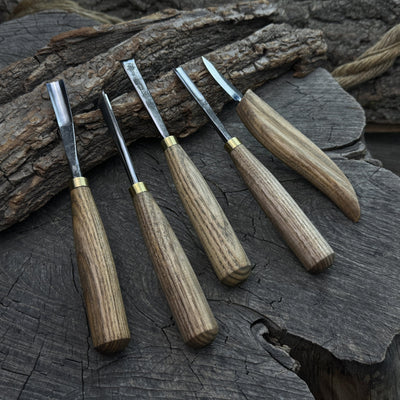 5-piece wood carving tool set with whittling knife and four chisels on wooden surface