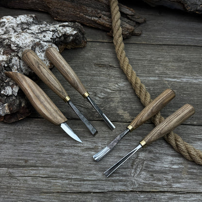 5-piece wood carving tool set with whittling knife and four chisels on wooden surface