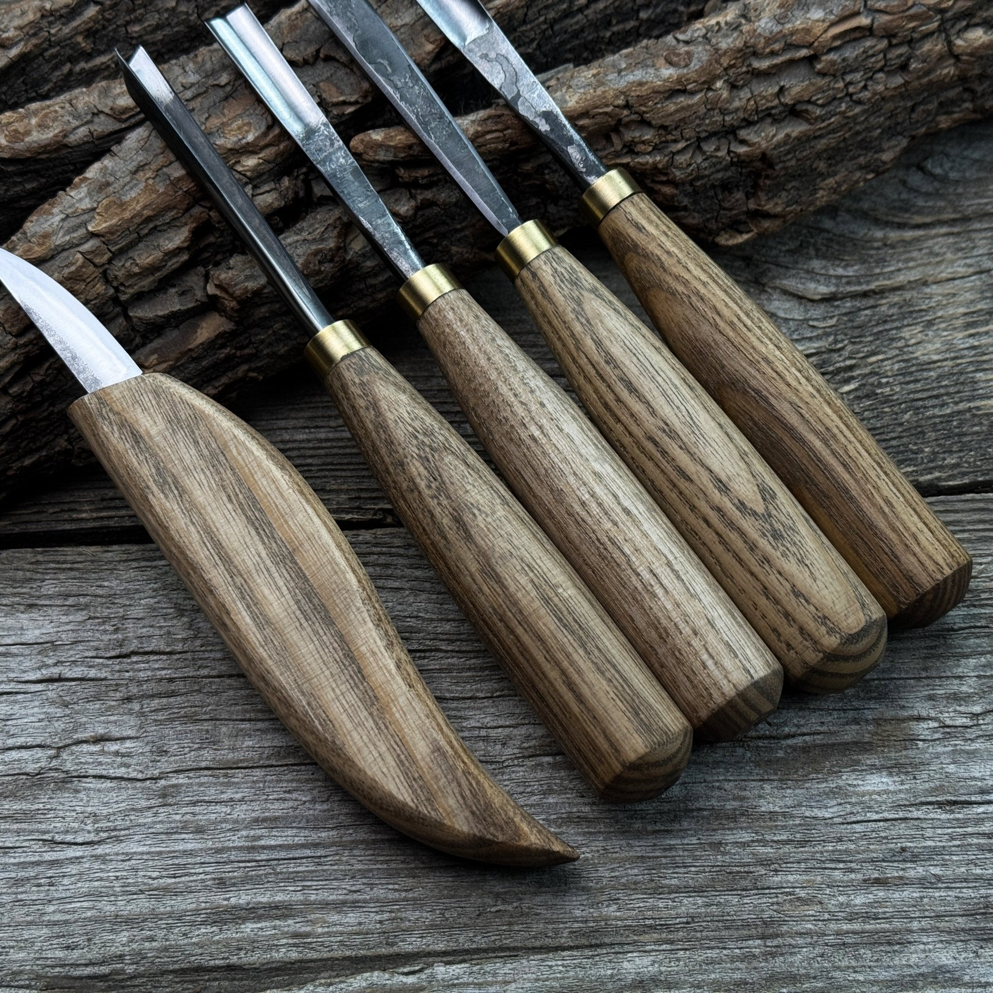 5-piece wood carving tool set with whittling knife and four chisels on wooden surface