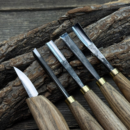5-piece wood carving tool set with whittling knife and four chisels on wooden surface