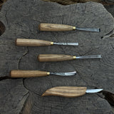 5-piece wood carving tool set with whittling knife and four chisels on wooden surface