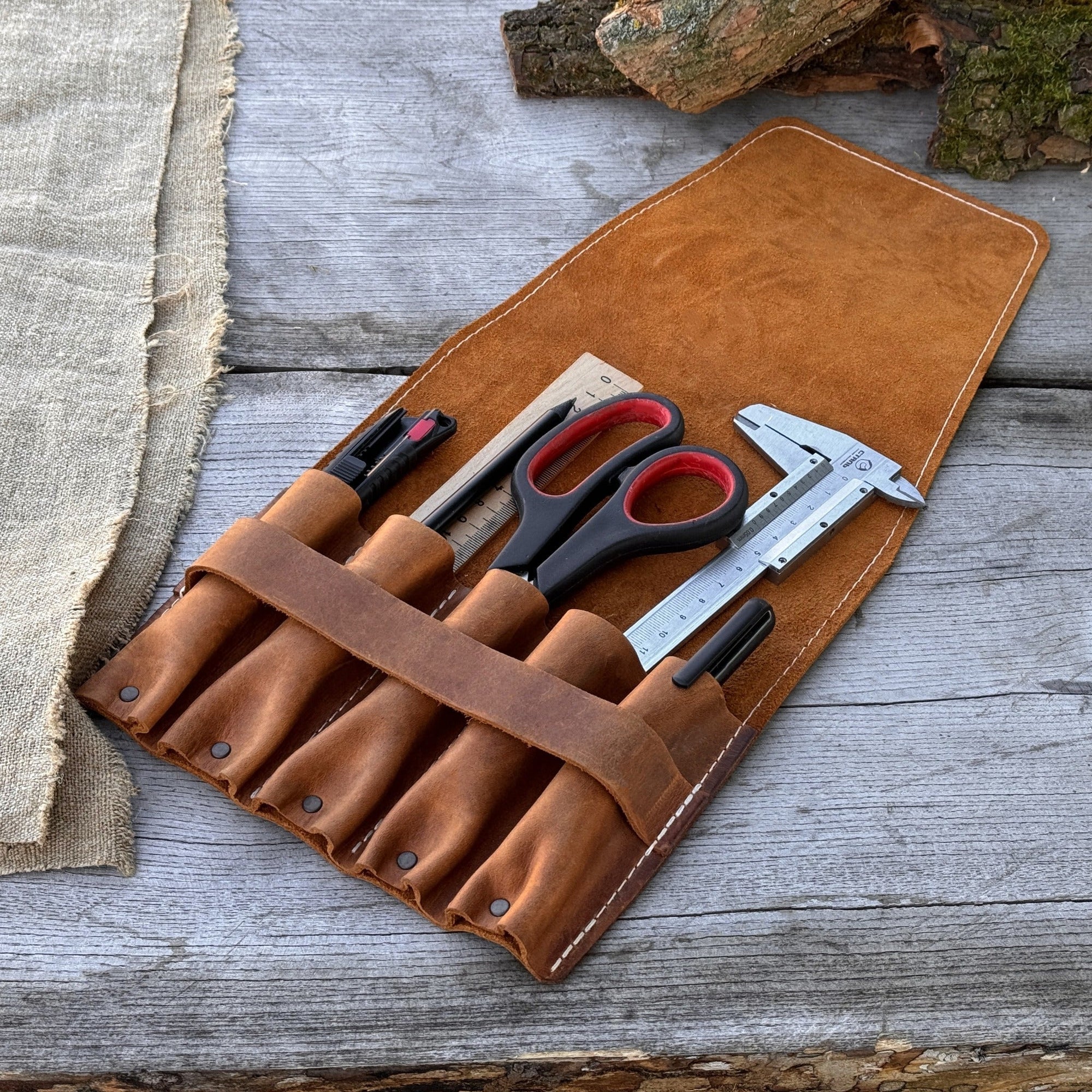 5-pocket leather tool case made from Crazy Horse leather with five tool pockets and leather strap closure