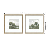 Two square framed prints side by side showing muted watercolor landscapes with olive green trees and grey skies, each with white matting and light brown wooden frames.