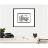 Black-and-white framed sketch of Florence's Duomo and Ponte Vecchio, displayed above a white desk with books, a cup, and a potted plant.